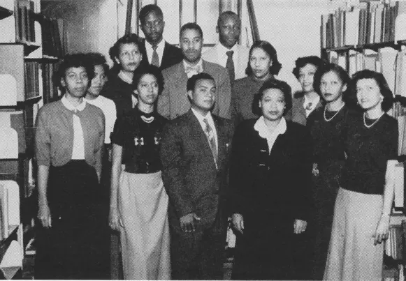 ALA Historical Grants Black and white image of group of men and women standing amidst library shelves